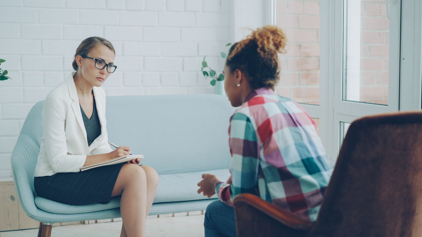 A psychiatrist listening attentively to a patient during a consultation